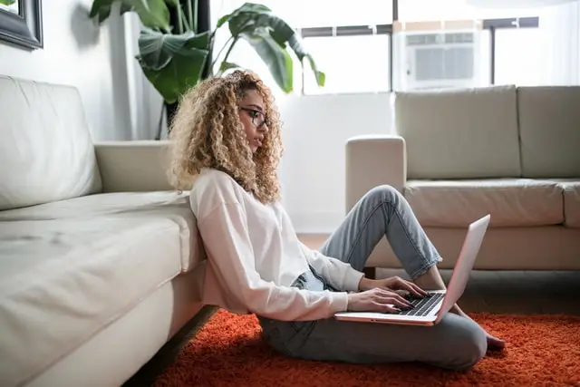 A lady sitting with a laptop